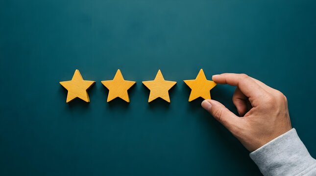 Hand placing yellow wooden star to complete four star rating on a dark green background for customer service feedback