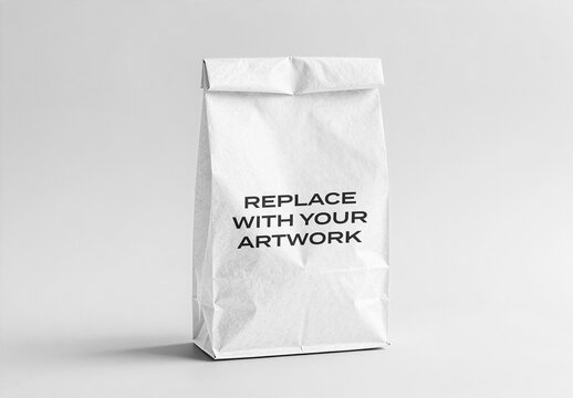 Paper lunch bag mockup with foldable top and textured surface, displayed on a neutral gray studio background, Template, realistic packaging presentation for branding graphic design