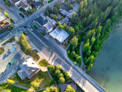 Panoramic drone shot of Banff village and alpine scenery on sunny day