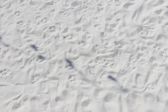 Fine white sand that glistens and reflects the sunlight.