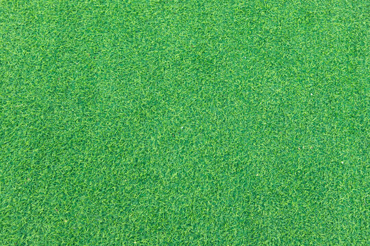 Close-up of lush green artificial grass, showcasing its detailed texture and vibrant color, perfect for outdoor landscaping and sports fields.