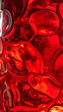Macro detail of hand blown antique stained glass with an uneven surface and natural imperfections