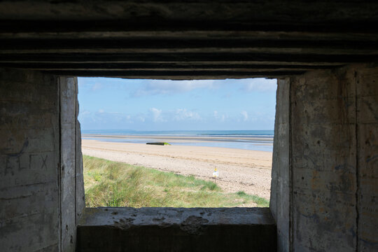 View of Utah Beach from inside a German concrete bunker at resistance nest Wn 10 in Normandy, France, showcasing the WW2 Atlantic Wall.