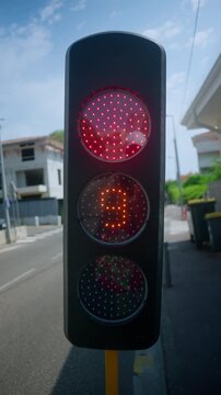 Traffic light with yellow signal blinking, warning drivers to proceed with caution on a city street