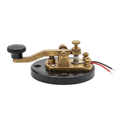 Vintage brass Morse code telegraph key with black base and wires © maximon4ik