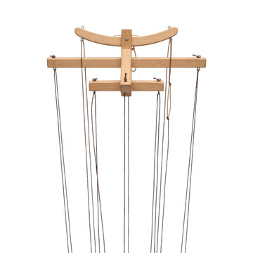 Wooden puppet control bar with multiple strings hanging down against a white background