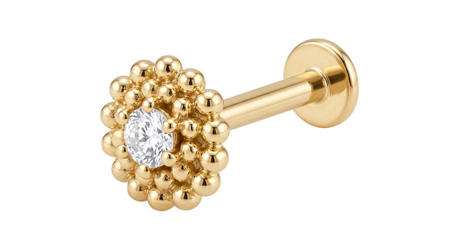 A luxurious gold labret piercing, adorned with a sparkling diamond in a textured beaded setting, perfect for elegant body jewelry.