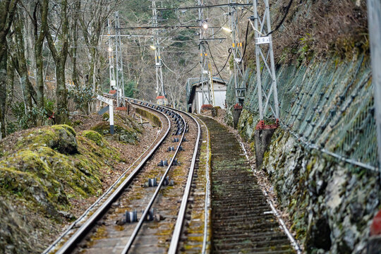 Funicular railway track ascending steep forested slope at Mount Rokko in Kobe Japan