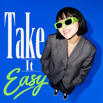 Poster for Take It Easy slogan with a smiling woman in green sunglasses on blue background.