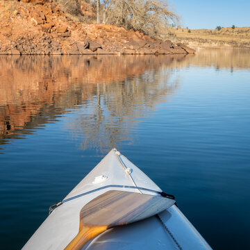 Horsetooth Reservoir at foothills of Rocky Mountains in northern Colorado - POV from expedtion canoe in warm winter scenery