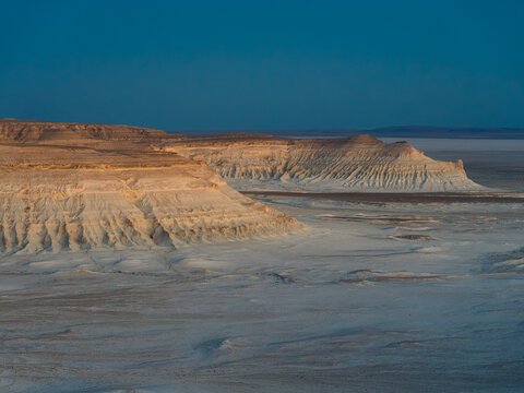 View of the dramatic white limestone cliffs and rock formations of Bozhira in the desert landscape of Karakiya District, Mangystau Region, Kazakhstan.