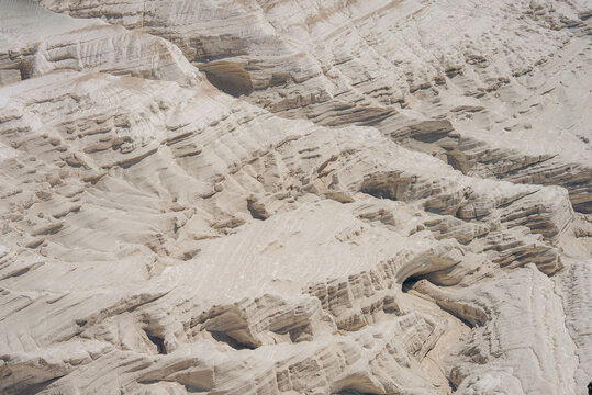 View of the white limestone rock formations of Bozhira with layered cliffs and desert terrain in Karakiya District, Mangystau Region, Kazakhstan.