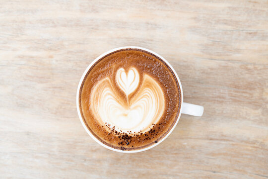 cappuccino on old grunge wooden table top view