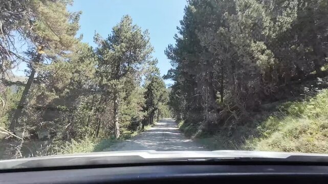 Driving a car on a bumpy road in the Pyrenees mountains
