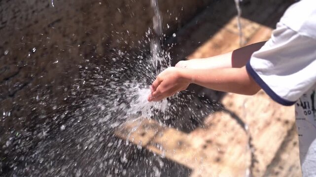 Child&rsquo;s hands under running water, playful water activity and everyday hygiene concept