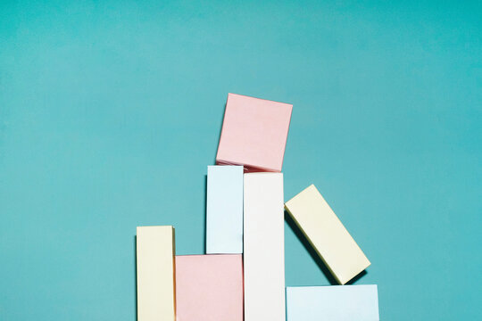 Pastel cardboard package tower on turquoise background