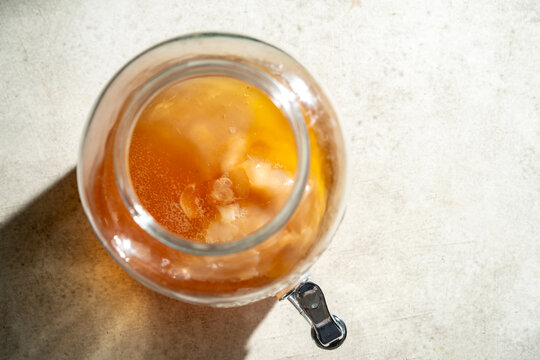 Homemade kombucha tea fermenting in a glass scoby jar