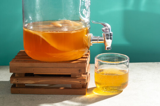 Homemade kombucha tea in glass dispenser with scoby
