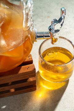 Homemade kombucha tea poured from scoby jar into glass