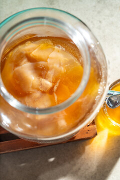 Homemade kombucha tea fermenting in a glass scoby jar