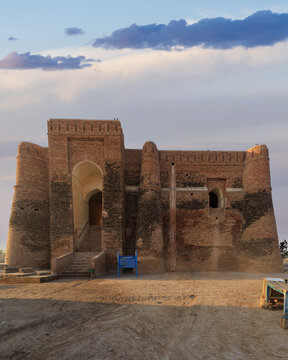 View of the 12th-century Shrine of Khalid Walid with its weathered brick walls and arched entrance under a clear sky in Kabirwala, Punjab, Pakistan.