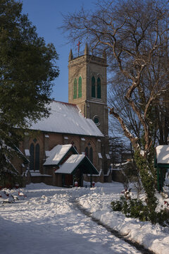 View of the historic Holy Trinity Church covered in fresh snow on a clear winter day in Murree, Punjab, Pakistan.
