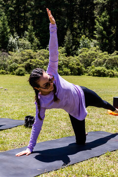 Woman practice outdoor pilates balance pose in nature