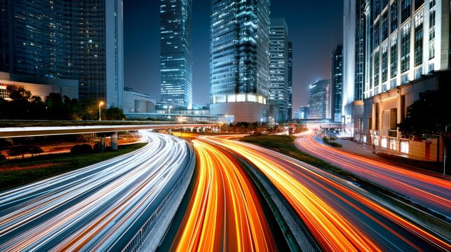 Nighttime cityscape with vibrant light trails of vehicle traffic showcasing modern skyscrapers and urban architecture in a bustling metropolitan area