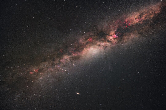 View of the Milky Way galaxy stretching across the dark night sky with vibrant nebulae and countless stars visible above Sopotnia Wielka, Silesian Voivodeship, Poland.