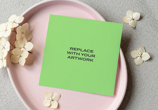 Square stationery mockup on a pink plate with dried hydrangea flowers, flat lay composition for branding, graphic design, print media or advertising display, template artwork replacement