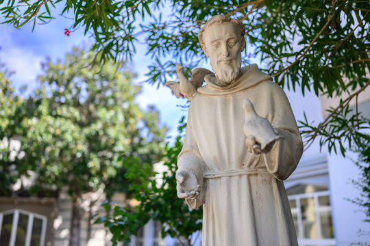St Francis of Assisi statue with doves at the Idente Missionaries headquarters in Rome, Italy.