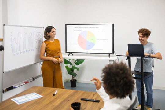 Coworking team present business data in modern office