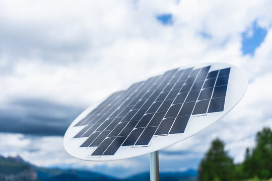 Solar panel against cloudy sky in a natural landscape