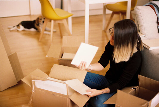 Woman stack cardboard box in warehouse storage area