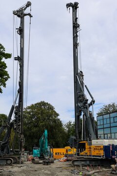 Gothenburg, Sweden - 13. August 2026: Heavy machinery including Liebherr pile drivers and an excavator preparing a foundation