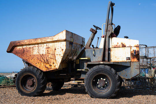 Rusty old dump truck and site dumper with weathered metal body