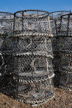 Stacked lobster pots and crab traps with weathered rope fishing gear