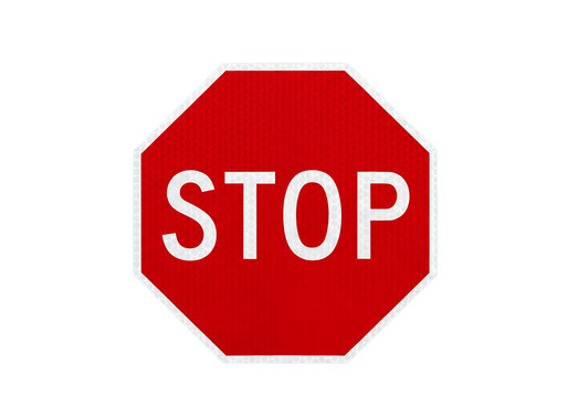 Red stop sign with white text isolated on a white background for traffic safety concepts.