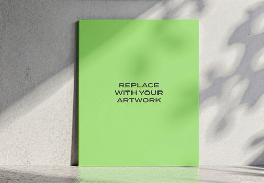 Vertical poster mockup displayed on a textured interior wall, realistic presentation with natural light and plant shadows, wooden floor, contemporary graphic design branding display