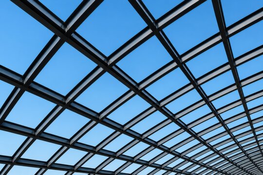 Modern glass roof structure with a clear blue sky background view