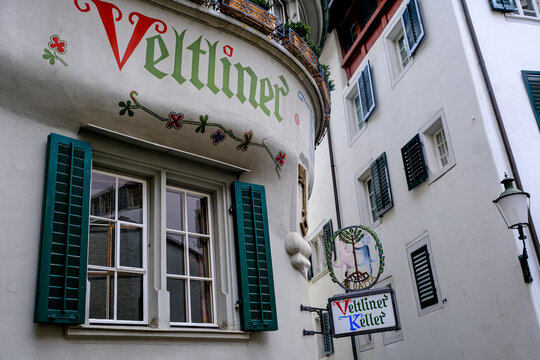 Zurich, Switzerland - March 15, 2026. A low-angle exterior shot captures the historic facade of the Veltliner Keller restaurant in Zurich, Switzerland. The building features an ornate bay window struc