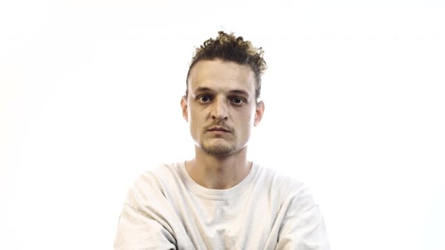 Confident Man with Arms Crossed Showing Different Facial Expressions on White Background