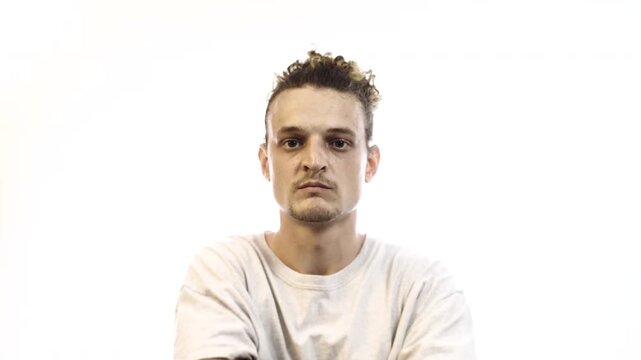 Confident Man with Arms Crossed Showing Different Facial Expressions on White Background