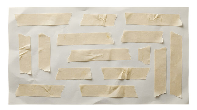 Collection of beige masking tape pieces on a textured paper background