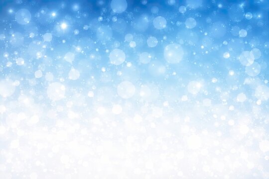 Blue abstract light background with soft glowing bokeh and sparkles
