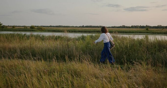 Caucasian man with long hair and Ukrainian traditional folk attire run away being chased . 4K 10-bit