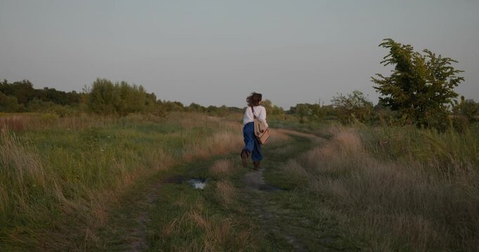 Caucasian man with long hair and Ukrainian traditional folk attire run away being chased . 4K 10-bit
