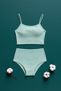 Mint green cotton lingerie set flatlay on teal background for ecommerce product display and catalog banner