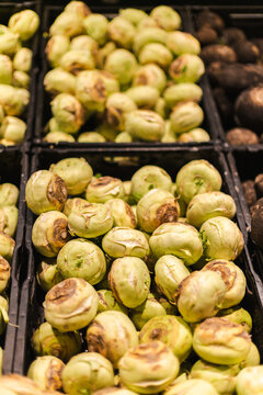 Fresh kohlrabi vegetables arranged in supermarket crates with healthy organic produce and grocery shopping concept