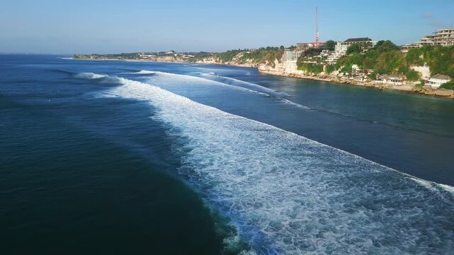 Aerial view with ocean waves and surfers in ocean on Balangan beach. Surfing and waves